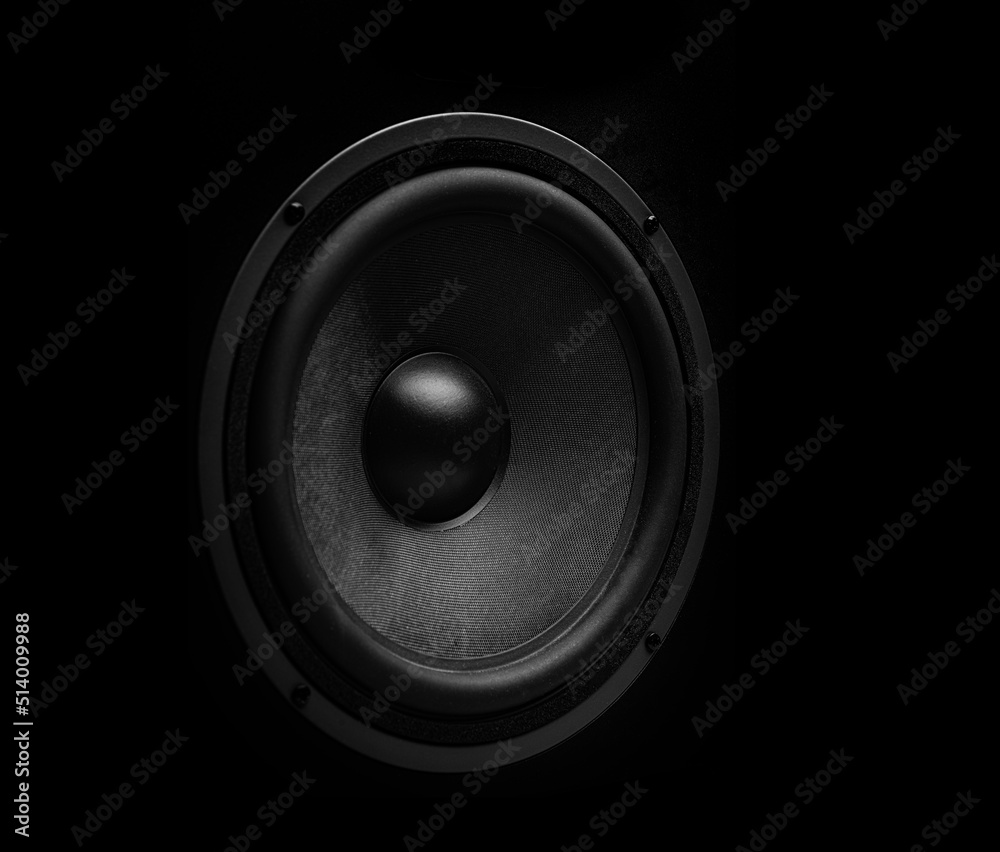 Beautiful powerful sound speaker close-up on a dark background. Beautiful powerful sound speaker close-up on a dark background.