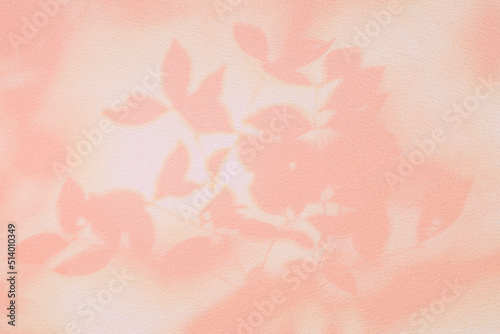 Shadow and light of leaves tree branch background. Natural colorful leaf pastel pink beige, rose gold shadow and light from sunlight on white wall texture for wallpaper overlay effect and design