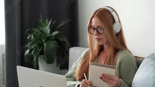 Young freelance business woman working at home. Talking on videochat with customer in workplace in living room at home. Self-isolation at COVID-19 Pandemic. 4k footage