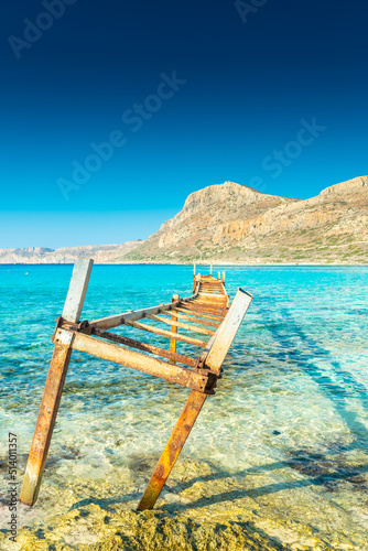 Old rusty jetty on the amazing crystal clear water of Balos Lagoon, Crete, Greece