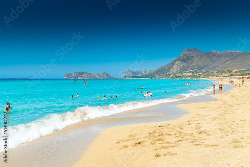 Fototapeta Naklejka Na Ścianę i Meble -  Falassarna, Greece, 13 June 2022:  Tourists on the sandy beach of Falassarna in Crete Island