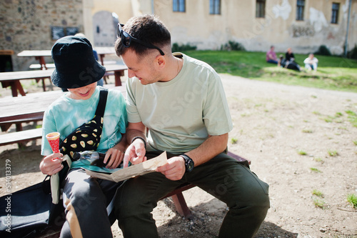 Father with son on a tour looking at map of Veveri castle, Czech Republic. photo