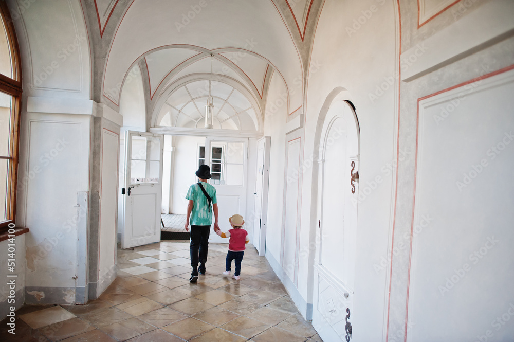 Brother with little sister walking at Veveri castle, Czech Republic.
