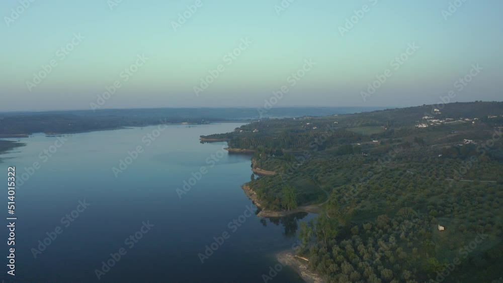 Aerial View Over A Mountain Dam With Fog in the background Before Sunrise Aerial View Over A Mountain Dam With Fog in the background Before Sunrise