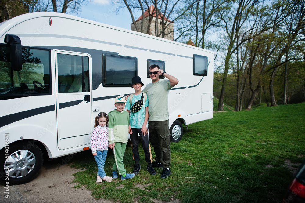Father with three children travel at motorhome RV camper van.