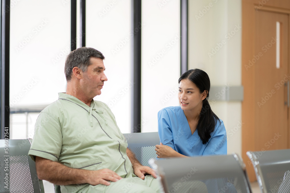 Obraz premium Doctor talk with elderly man sitting on the chair in hospital. Doctor explain on diagnosis and treatment to patient. Nurse encourages man. Fully recover after successful surgery. Healthcare medical