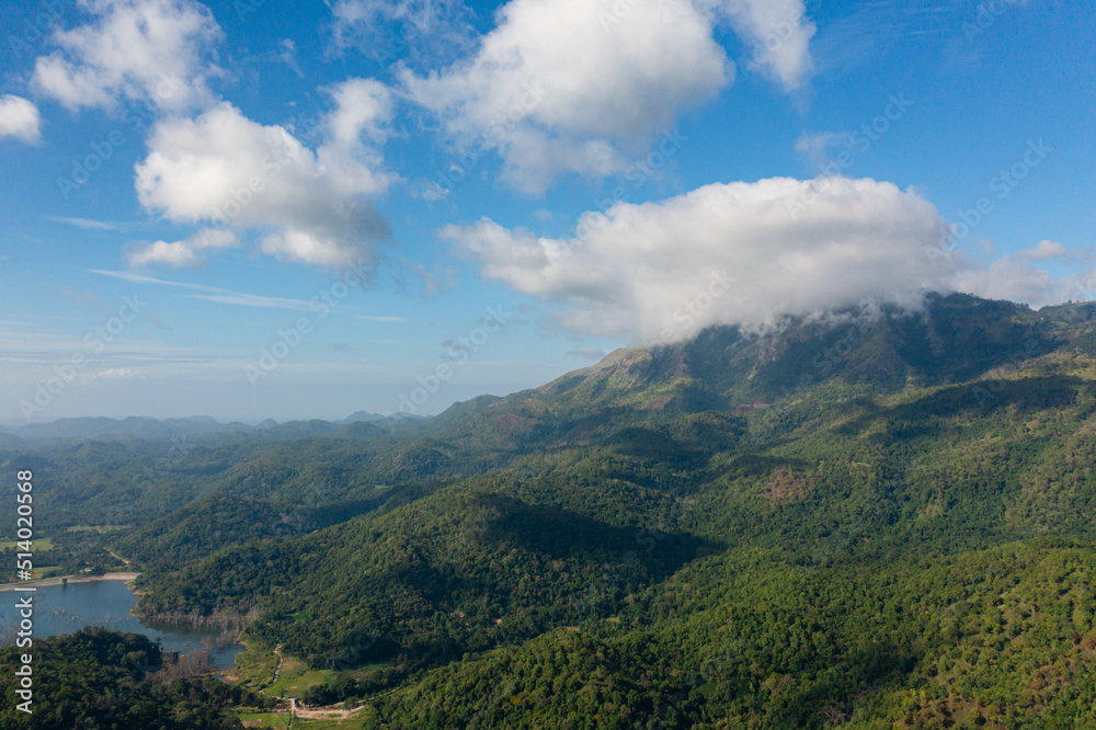 Beautiful lake and jungle in the valley against the background of mountains and clouds.Sri Lanka. Beautiful lake and jungle in the valley against the background of mountains and clouds.Sri Lanka.