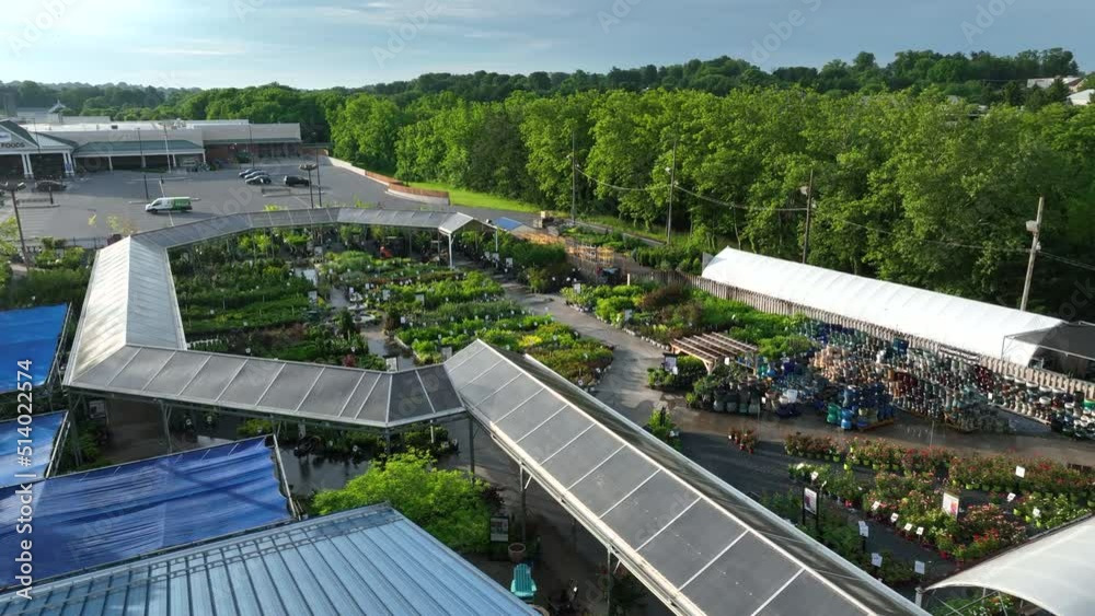Outdoor greenhouse for flower shrubbery sales. Aerial view in USA during golden hour light.
