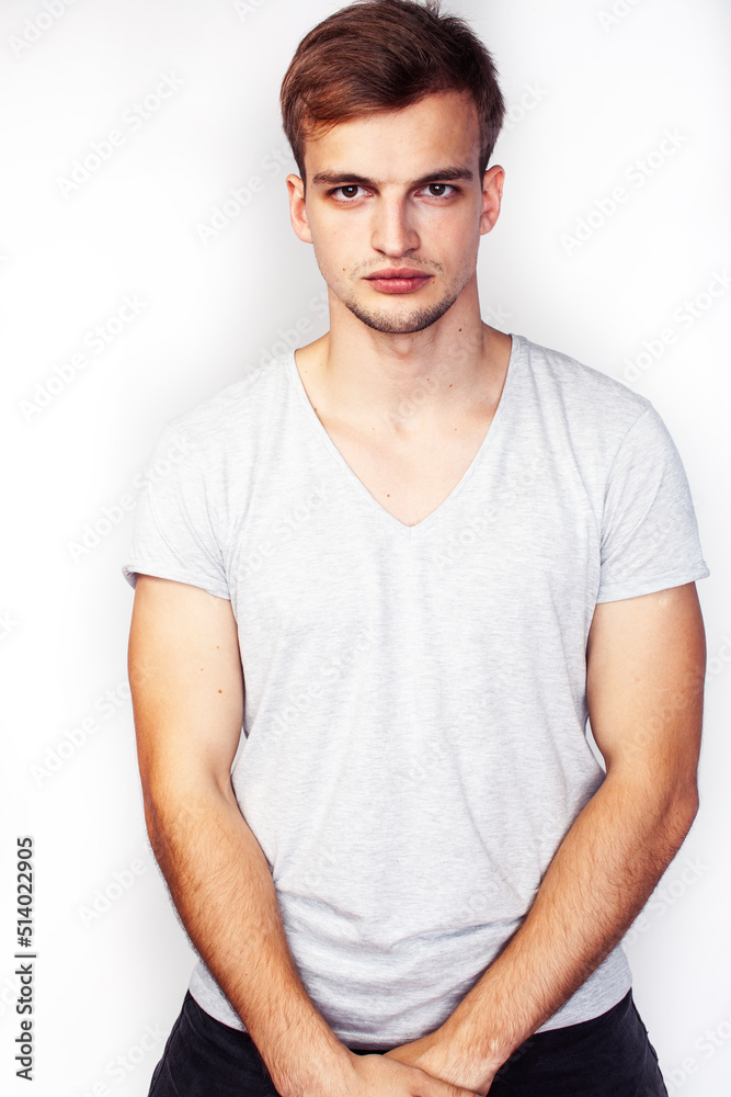 Obraz premium young handsome teenage hipster guy posing emotional, happy smiling against white background isolated, lifestyle people concept