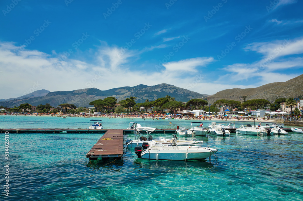 Palermo, Sicily - July 29, 2016: Coast of the sea with a pier and boats. Mediterranean resort in Italy