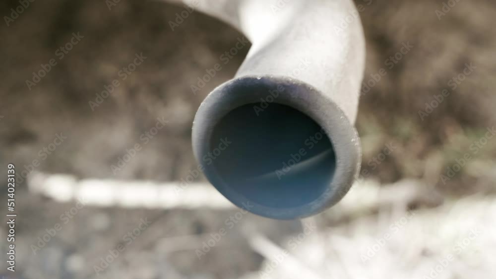 Close-up of the exhaust pipe of a diesel car with the engine running. Products of incomplete combustion from the muffler of the car