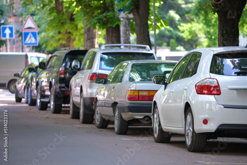 City traffic with cars parked in line on street side