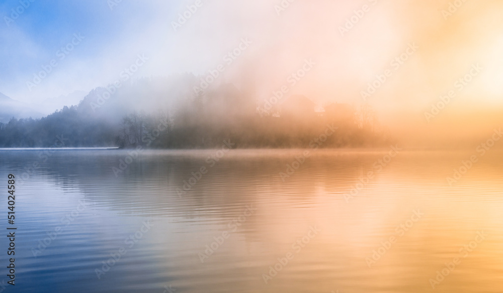 beautiful foggy morning at lake bled with mist and sun. 