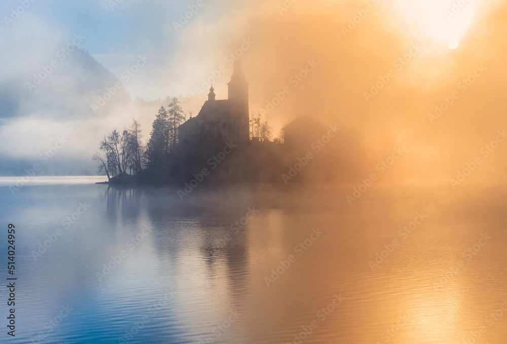 beautiful foggy morning at lake bled with mist and sun. 