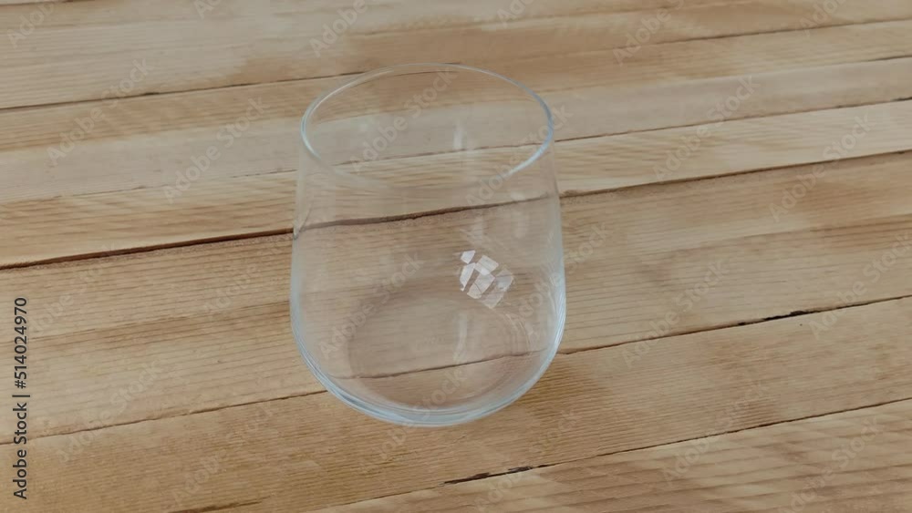 Empty glass for whiskey or cognac on wooden background Empty glass for whiskey or cognac on wooden background