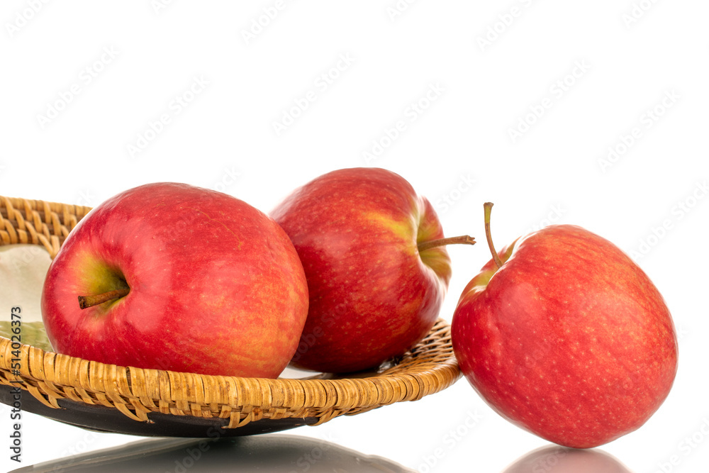 Three juicy red apples with a ceramic plate, close-up, isolated on a white background. Three juicy red apples with a ceramic plate, close-up, isolated on a white background.