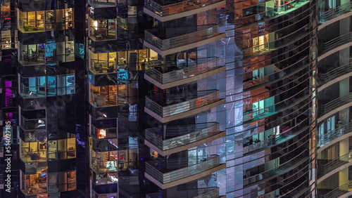 Night view of glowing windows in apartment tower timelapse. © neiezhmakov