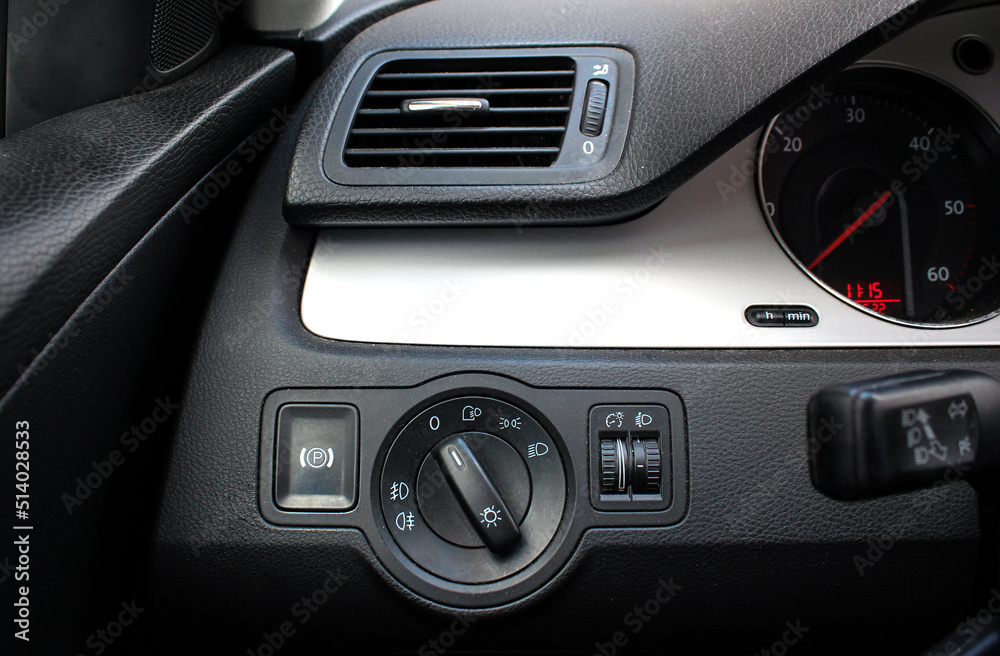 Car interior with light switch, automatic control of switching on and off the car light and Air ventilation grille with power regulator. Dashboard for switching on the headlights and fog lights.