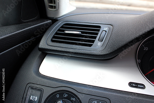 Car air vents close-up grille. Air ventilation grille with power regulator. Modern Car air conditioner, interior of a new modern car. © Best Auto Photo