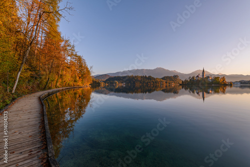 Wooden pier at lake Bled in the early morning. Beautiful and calm destination for a morning walk.