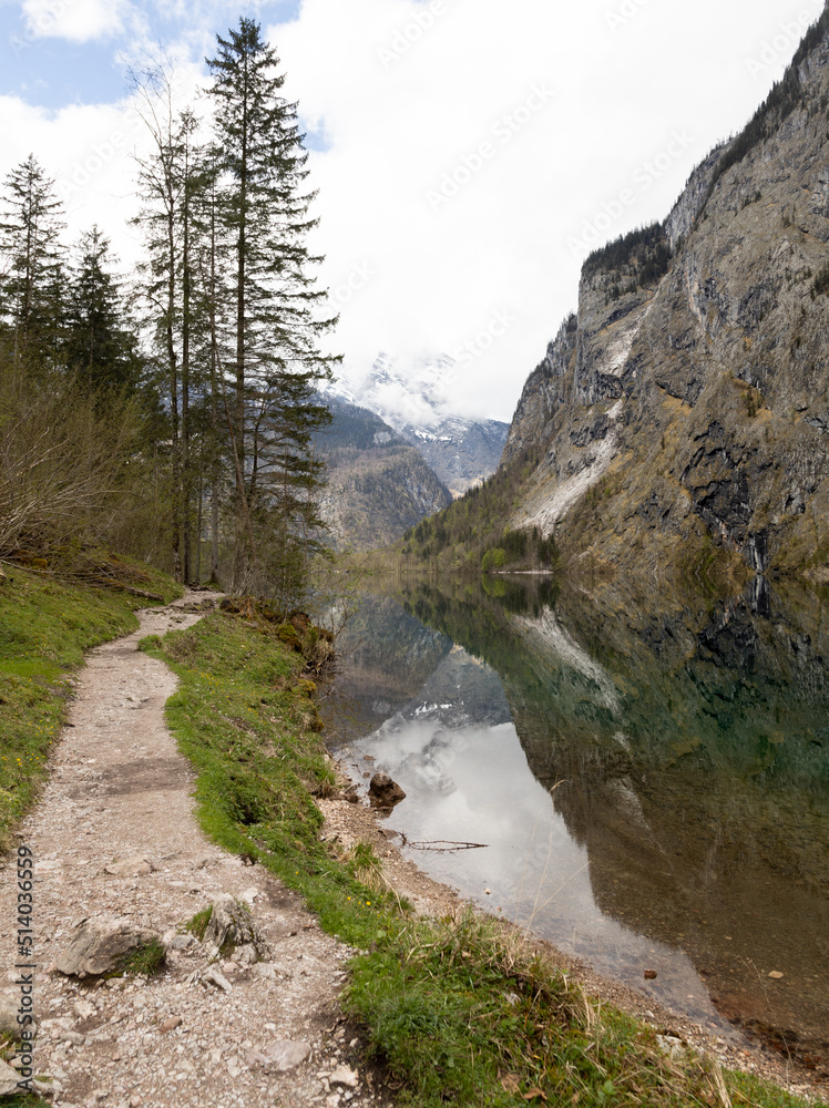 Trail path near a lake in the alps Trail path near a lake in the alps