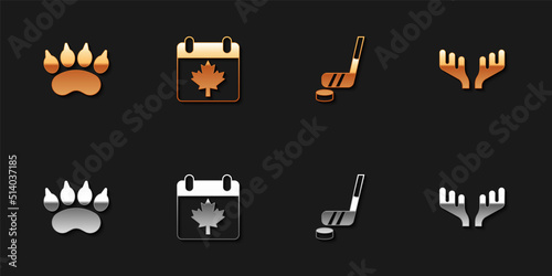 Set Bear paw footprint, Canada day with maple leaf, Ice hockey stick and puck and Deer antlers icon. Vector