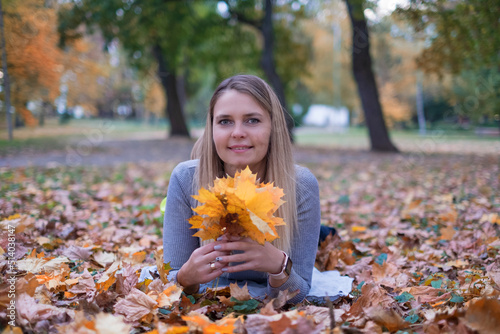 Girl in autumn leaves and colours