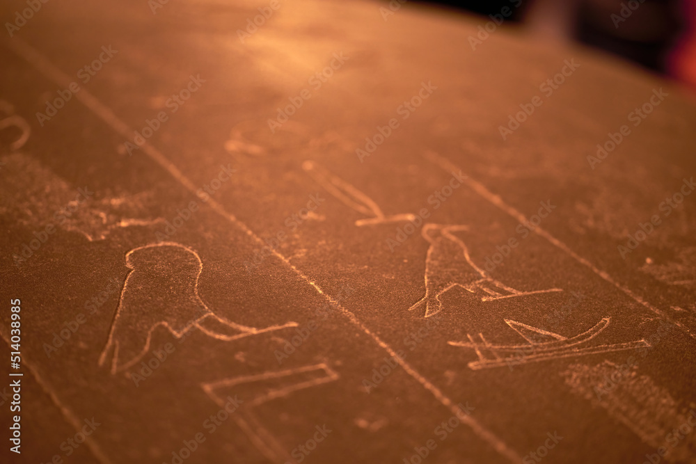 Naklejka premium Hieroglyphic carving on an ancient Egyptian sargophagus in an ancient temple, selective focus