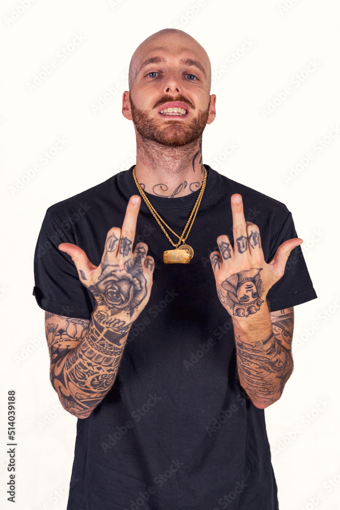 tattooed rap singer posing in studio wearing black clothes - obrazy, fototapety, plakaty 