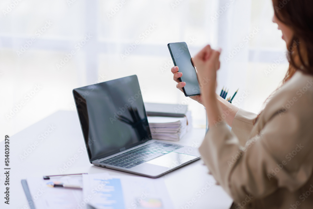 Yes, Excited happy woman looking at the phone screen, celebrating an online win, overjoyed young Asian female screaming with joy, isolated over a white blur background Yes, Excited happy woman looking at the phone screen, celebrating an online win, overjoyed young Asian female screaming with joy, isolated over a white blur background