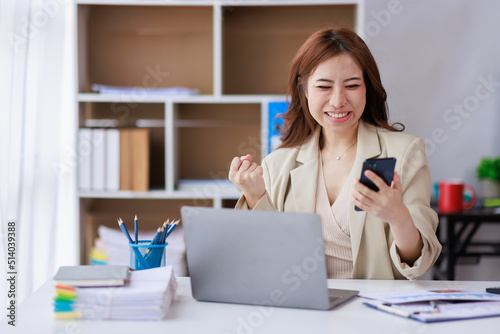 Yes, Excited happy woman looking at the phone screen, celebrating an online win, overjoyed young Asian female screaming with joy, isolated over a white blur background