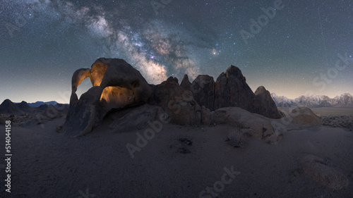 Rocky formations on mountain under starry sky in twilight