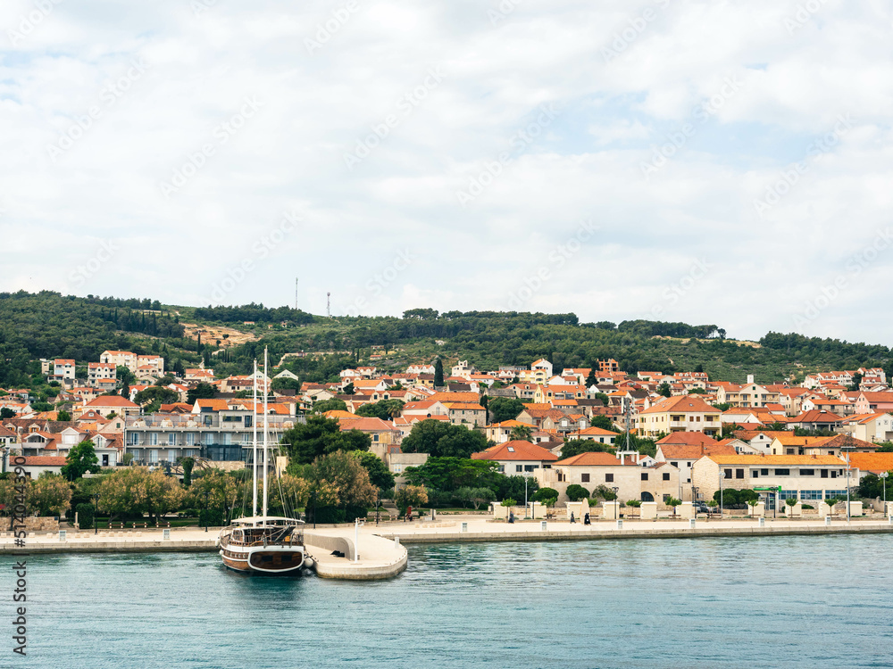 Waterfront view with boat and houses in Supetar, Brac Island Croatia