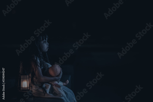 sad child ghost at night,Halloween Festival concept,Friday 13th,Horror movie scene,A girl with doll