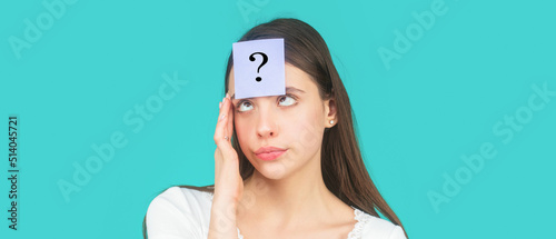 Paper notes with question marks. Doubtful girl asking questions to himself. Confused female thinking with question mark on sticky note on forehead. Thinking woman with question mark looking up photo