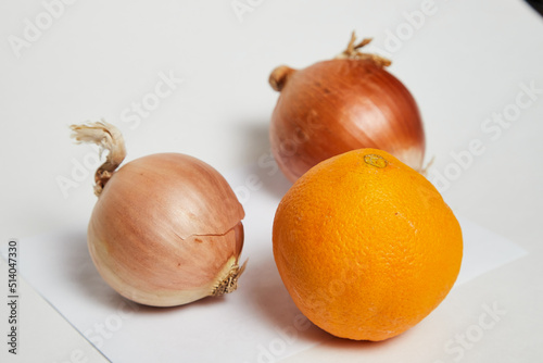 Wallpaper Mural Ripe orange and onion on a white background. The concept of healthy nutrition and vitamins in various fruits and vegetables. The concept of poverty and wealth, vitamins for the poor and rich Torontodigital.ca