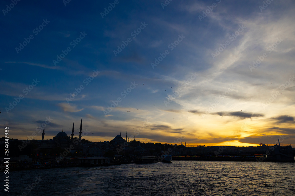Istanbul silhouette at sunset from a ferry. Cityscape of Istanbul