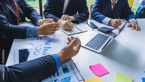 Tableau sur toile Smooth Focus , group of business venture capitalists are studying the market and planning their investments to get the best return for them and listening to advice from an investment advisor