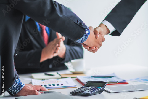 A group of business people who are joining hands as a symbol of investment and doing business together after consulting with investment advisors and planning their investments carefully. photo