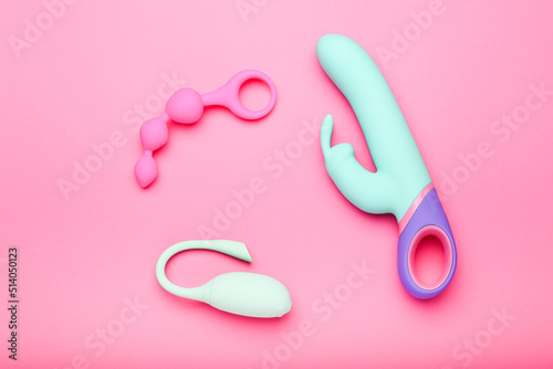 collection of different sex toys for adults on a pink background