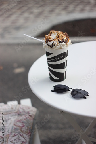 Cup of coffee with cream and nuts