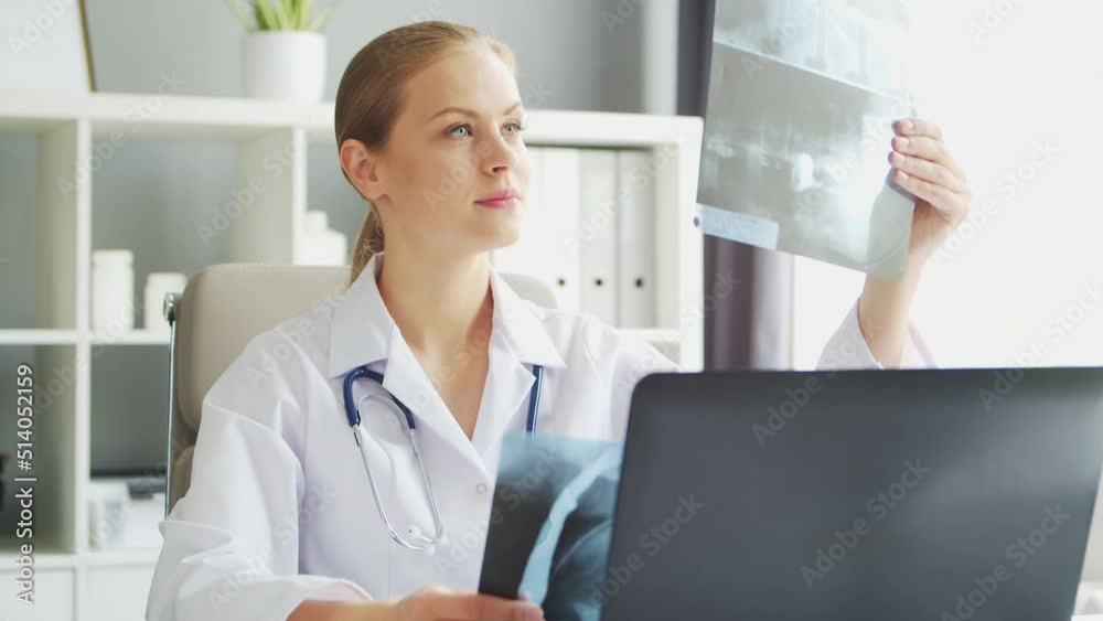 Doctor Works in the Medical Office. Woman in White Coat. Workplace of a Professional Female Therapist in a Hospital or Clinic. Healthcare and Medicine. Doctor Works in the Medical Office. Woman in White Coat. Workplace of a Professional Female Therapist in a Hospital or Clinic. Healthcare and Medicine.