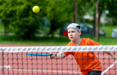 Child with tennis racket on tennis court. Training for young kid, healthy children. Horizontal sport theme poster, greeting cards, headers, website and app © Augustas Cetkauskas