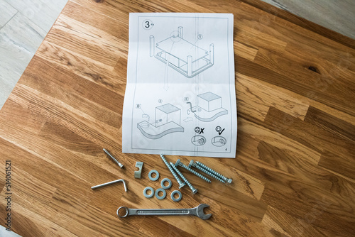 tools and instructions for assembling a wooden table
