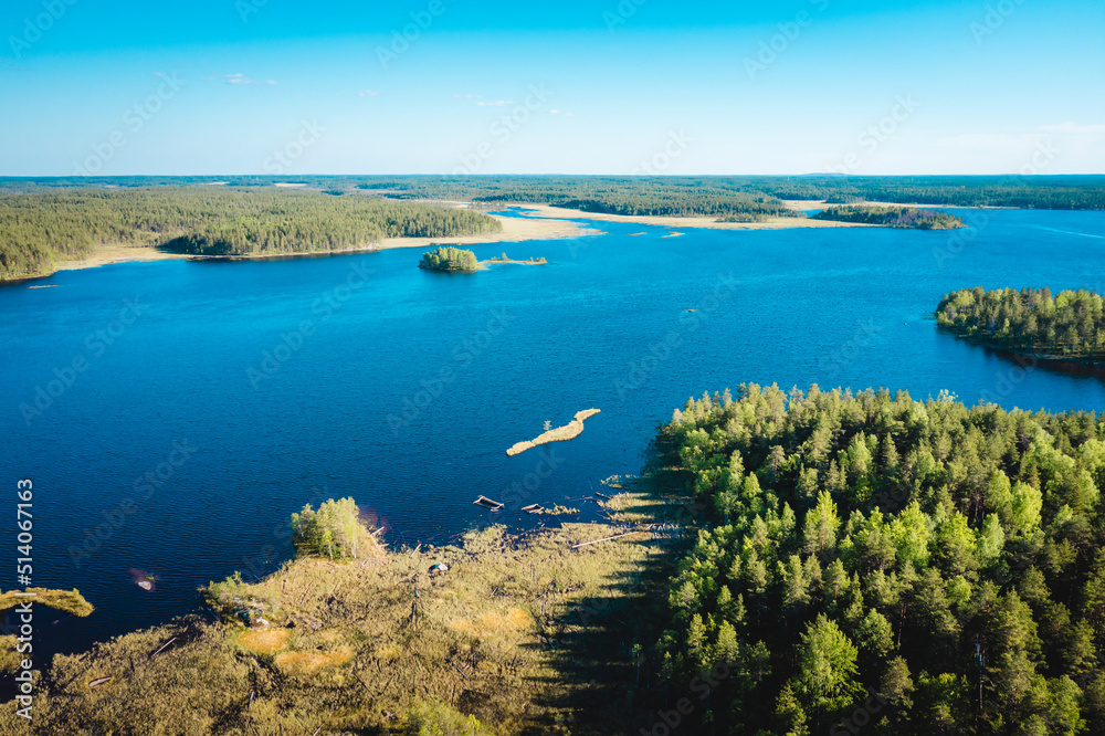 Aerial view on Karelian lake Lindozero. Lake in Karelia in summer. Blue lake and green forest top view