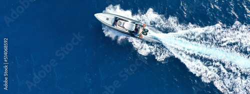 Aerial drone ultra wide photo with copy space of luxury inflatable rib speed boat cruising in mediterranean deep blue sea © aerial-drone