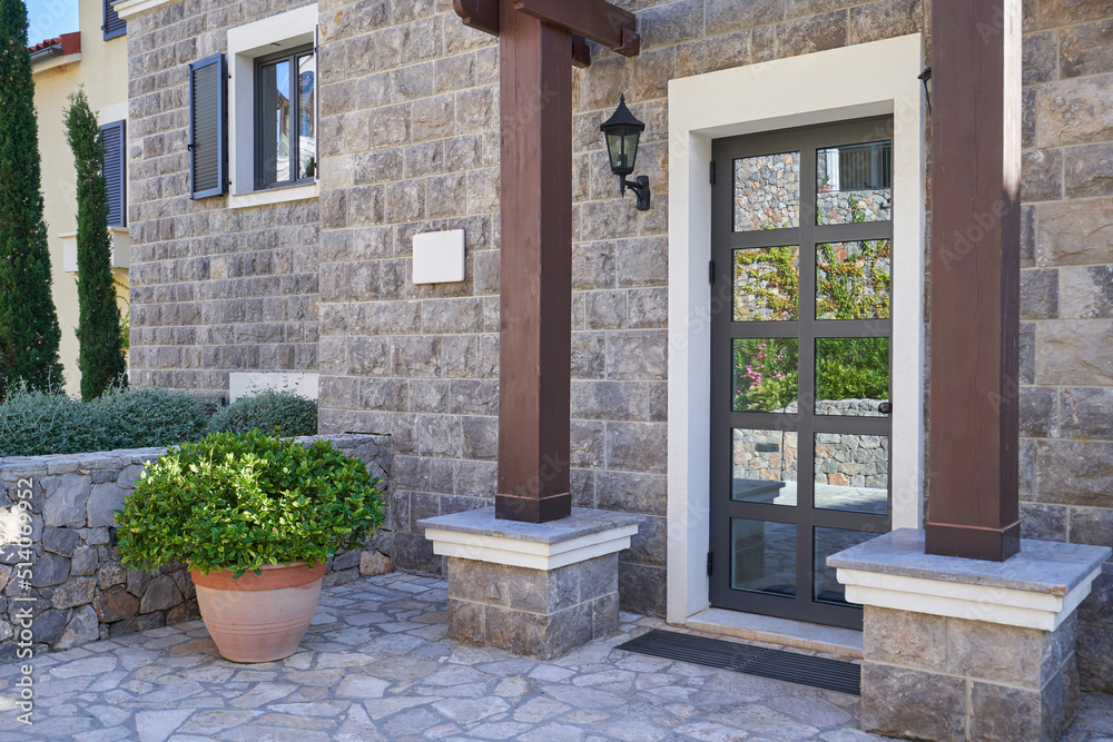 Entrance to the house with glass door and stone finished wall Stock ...