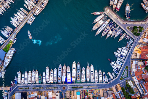 Aerial view of Marmaris harbor with yacht and sailboat. Colorful landscape of evening Turkish city.