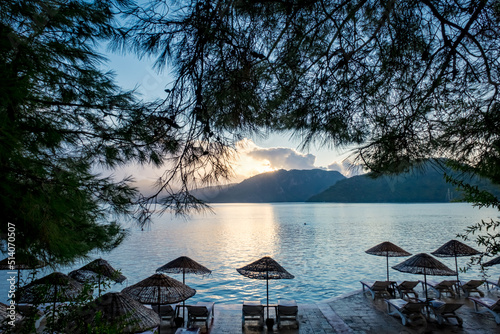 Summer scenery on the Mediterranean coast in Turkey near Marmaris and Icmeler. Just after dawn. View of the bay and mountains through pine branches photo