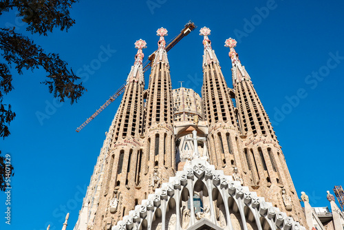 Sagrada Família is a Large Unfinished Minor Basilica in the Eixample District of Barcelona, Catalonia. Below View of Famous Architecture with Blue Sky.